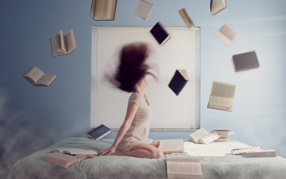 girl in bed whipping hair books flying